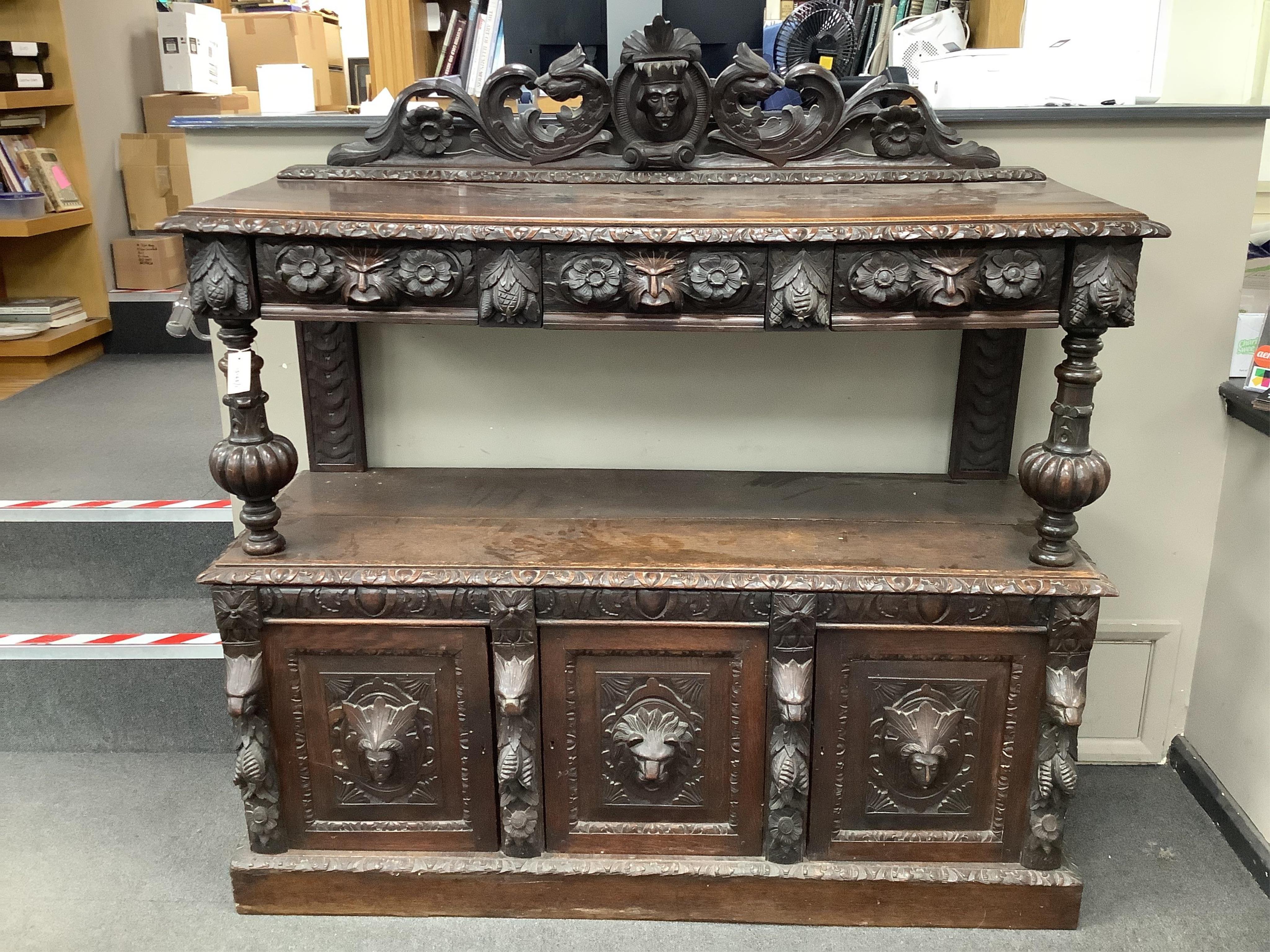 A late 19th century Flemish carved oak buffet, width 150cm, depth 55cm, height 155cm. Condition - fair